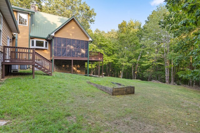 view of yard with a wooden deck and a sunroom