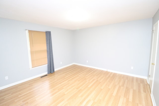 spare room with light hardwood / wood-style floors