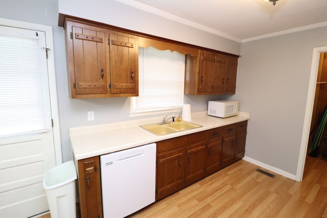 kitchen featuring white appliances, light hardwood / wood-style floors, crown molding, and sink