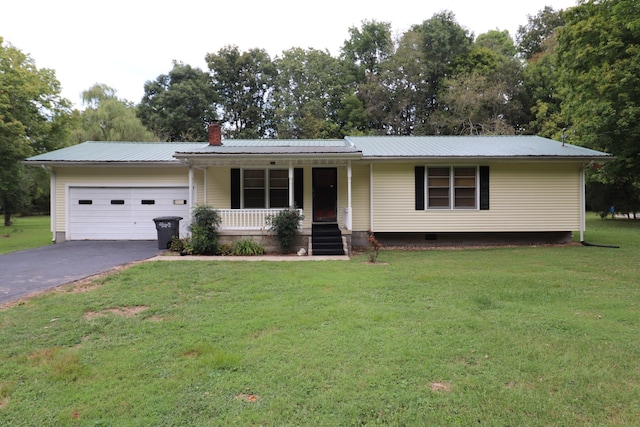 ranch-style home featuring covered porch, a garage, and a front yard