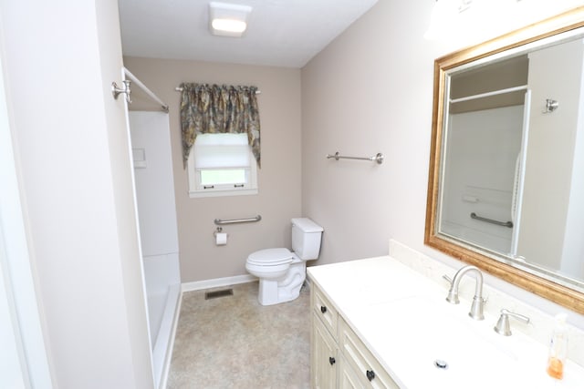 bathroom with vanity, toilet, and walk in shower