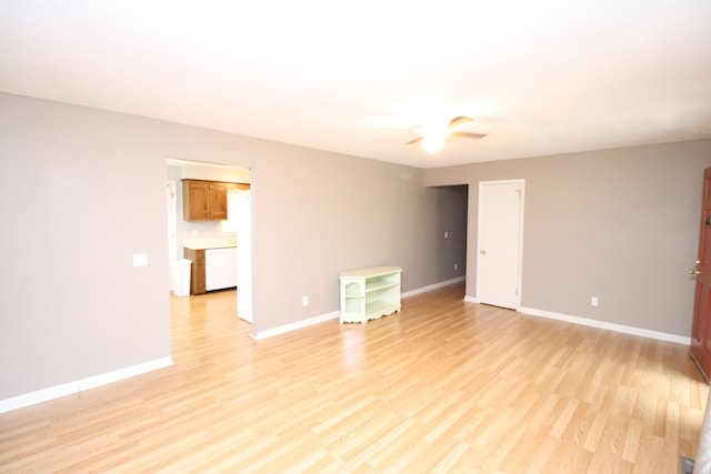 spare room with ceiling fan and light wood-type flooring