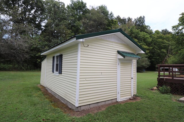 view of outbuilding with a yard