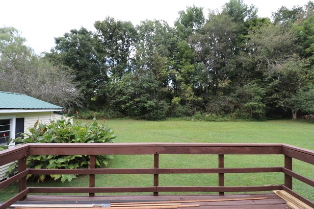 wooden deck featuring a yard