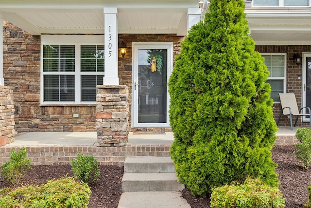 doorway to property featuring covered porch