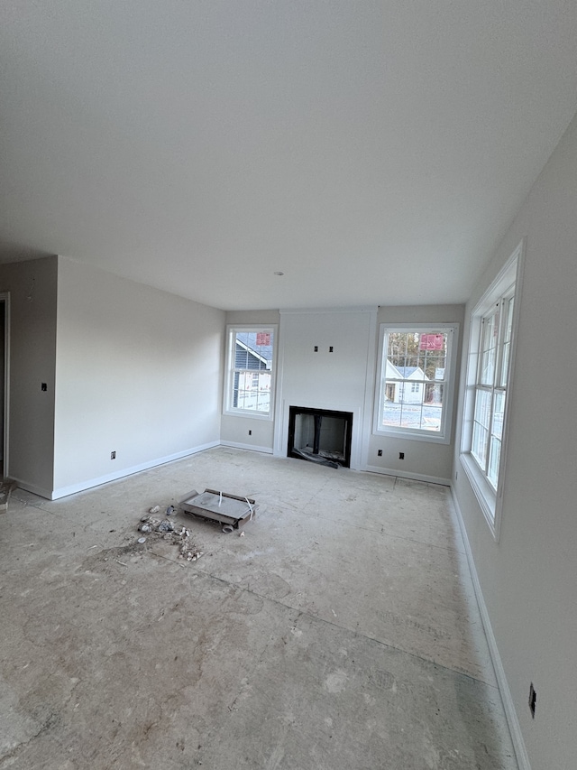 unfurnished living room featuring vaulted ceiling