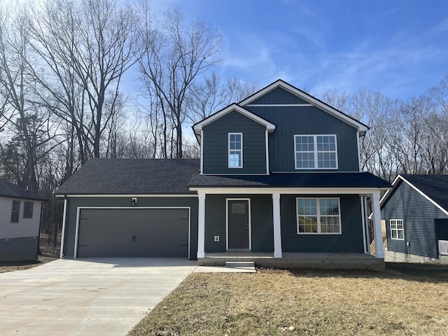 view of property featuring a porch and a garage