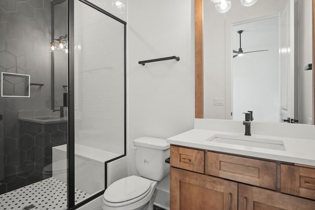 bathroom featuring a stall shower, vanity, and toilet