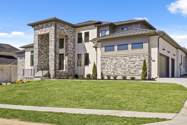 prairie-style home featuring concrete driveway, stone siding, metal roof, a standing seam roof, and a front yard