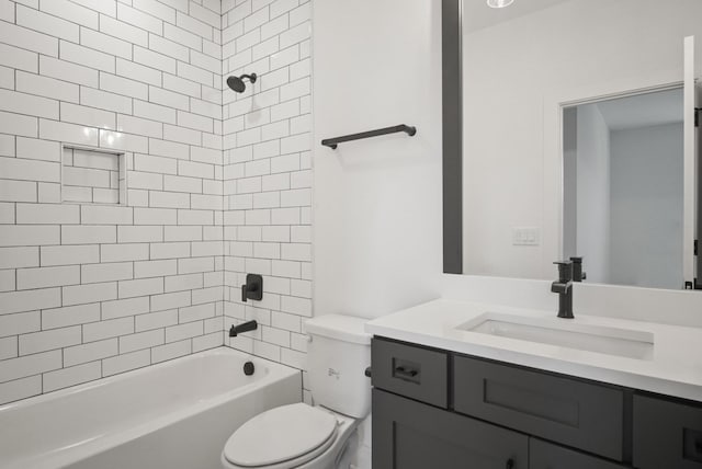 bathroom with bathtub / shower combination, vanity, and toilet