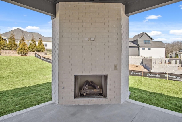 view of patio featuring an outdoor brick fireplace