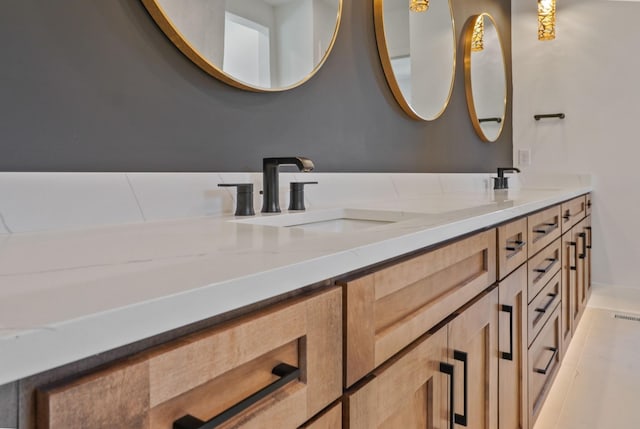 full bath featuring double vanity and a sink