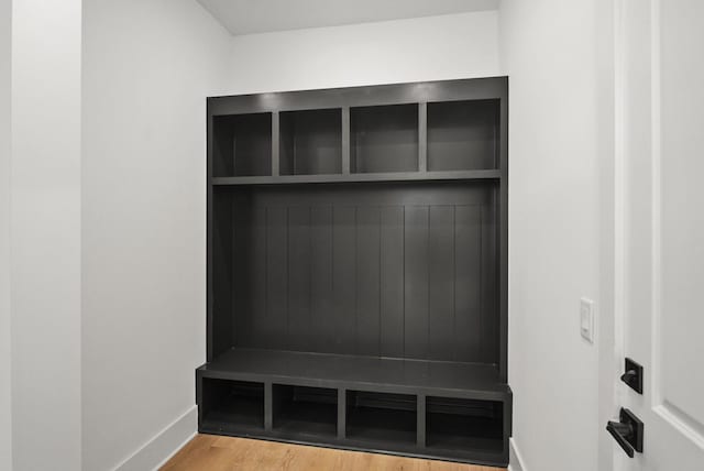 mudroom featuring wood finished floors and baseboards