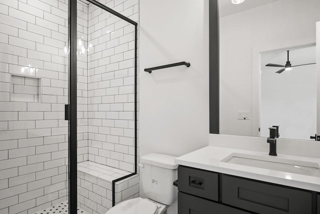 bathroom featuring vanity, a shower stall, toilet, and a ceiling fan