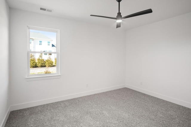 unfurnished room featuring carpet floors, visible vents, ceiling fan, and baseboards