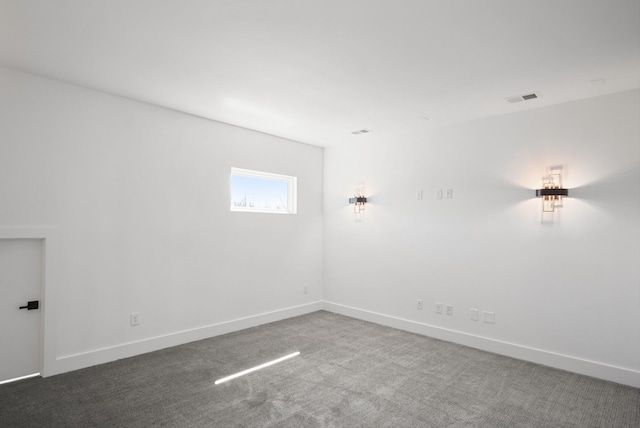 carpeted empty room with visible vents and baseboards