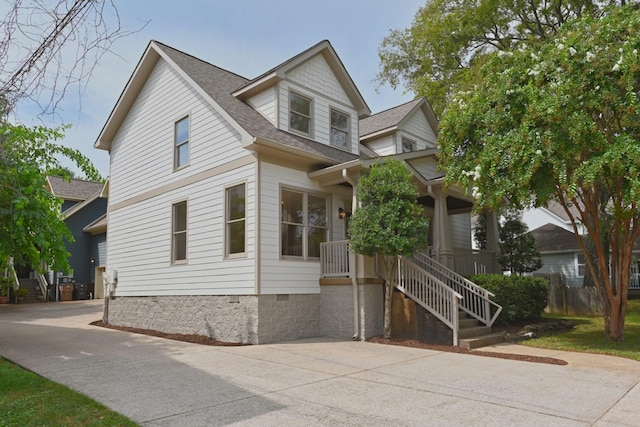 view of front of property featuring crawl space and a shingled roof