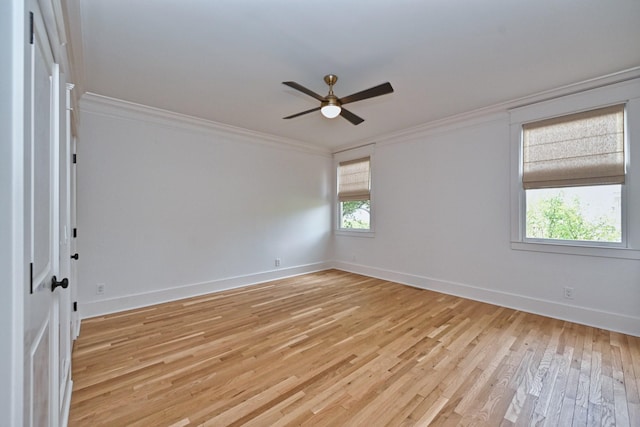 empty room with ceiling fan, light wood-type flooring, baseboards, and ornamental molding