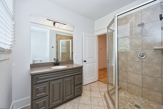 bathroom with vanity, a stall shower, and tile patterned flooring