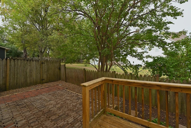 wooden terrace featuring a patio and a fenced backyard