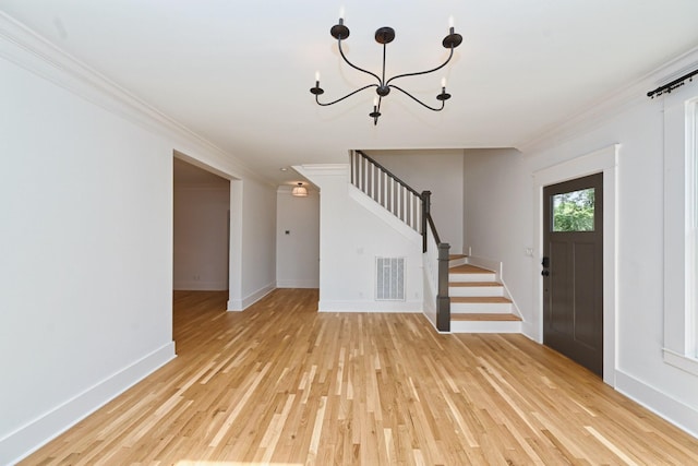 foyer featuring visible vents, stairway, crown molding, light wood finished floors, and baseboards