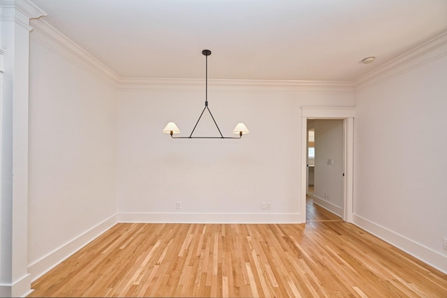 unfurnished room featuring baseboards, an inviting chandelier, crown molding, and light wood finished floors