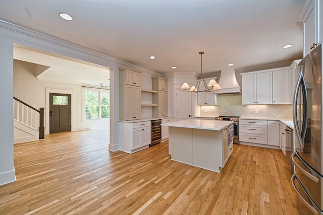 kitchen featuring premium range hood, wine cooler, a notable chandelier, stainless steel appliances, and open shelves