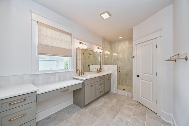 full bath with vanity, a shower stall, tasteful backsplash, and tile patterned floors