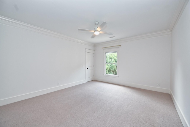 empty room featuring visible vents, baseboards, ceiling fan, light carpet, and crown molding