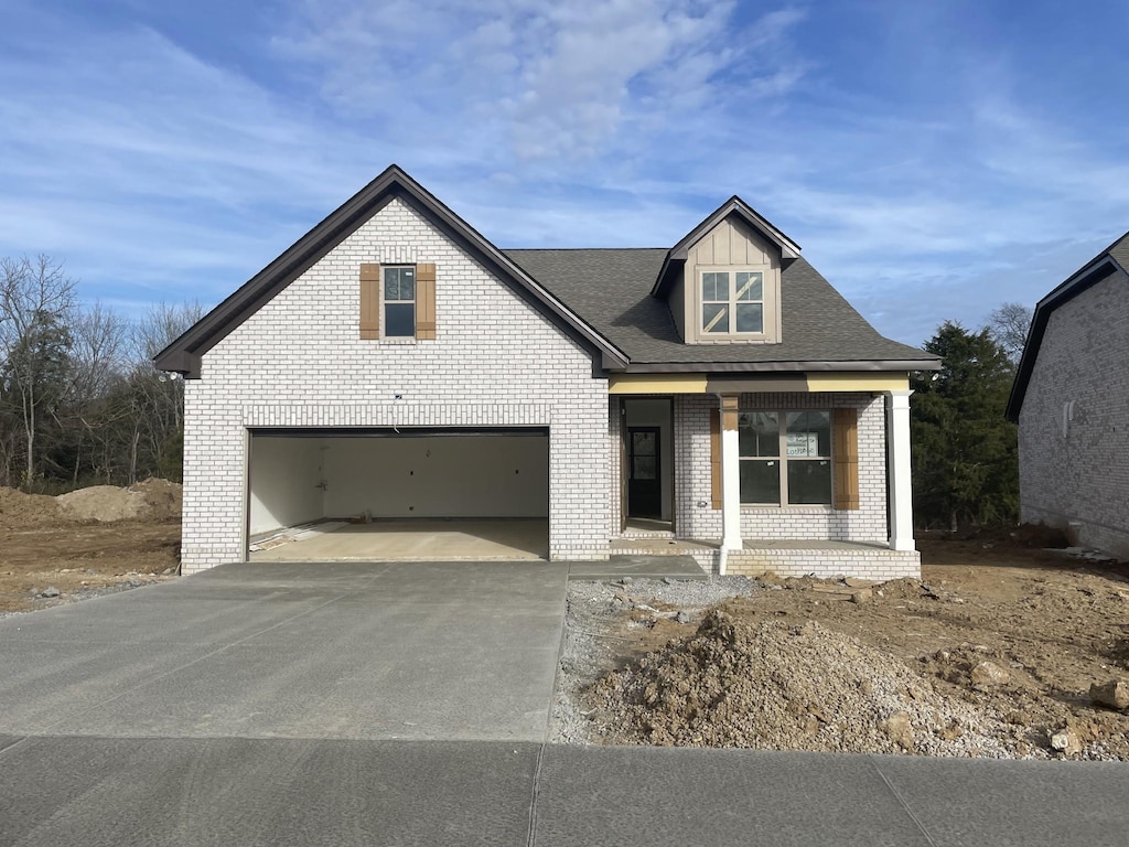 view of front facade with covered porch and a garage