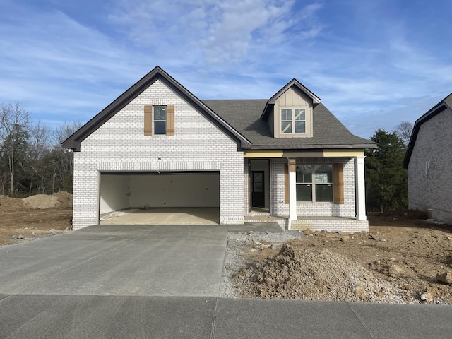 view of front facade with covered porch and a garage