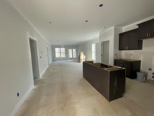 kitchen with a center island and baseboards