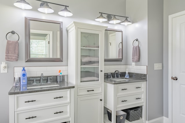 bathroom with decorative backsplash and vanity