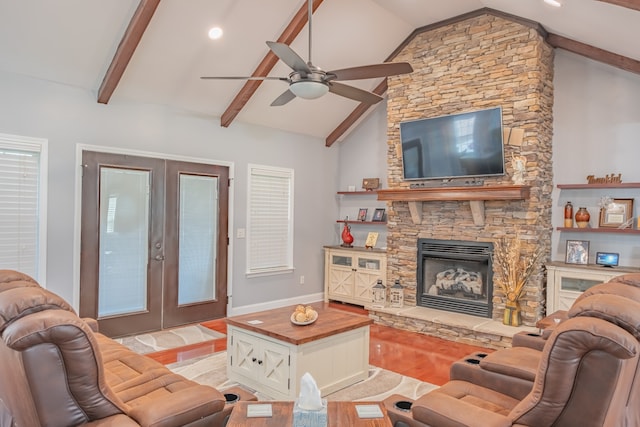 living room with ceiling fan, french doors, lofted ceiling with beams, a fireplace, and light hardwood / wood-style floors