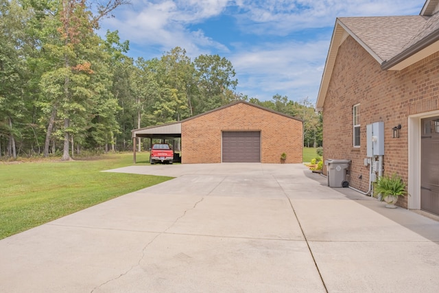 view of side of property with a yard, a carport, a garage, and an outdoor structure