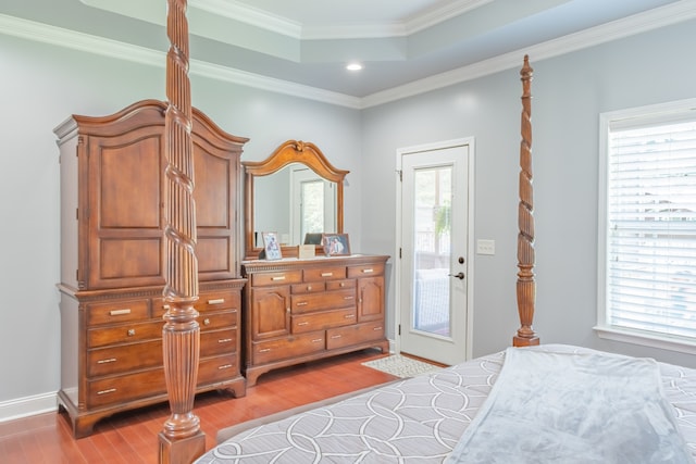 bedroom with multiple windows, access to outside, ornamental molding, and hardwood / wood-style floors