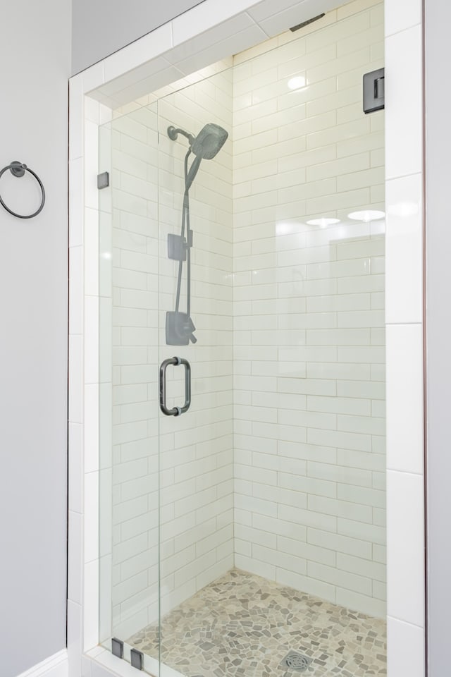 bathroom with a shower with shower door