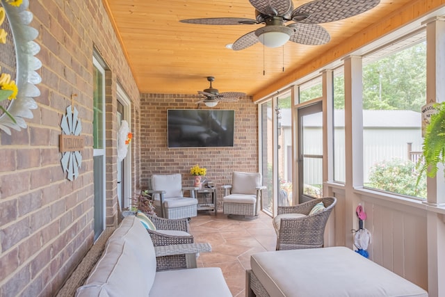 sunroom with wood ceiling and ceiling fan