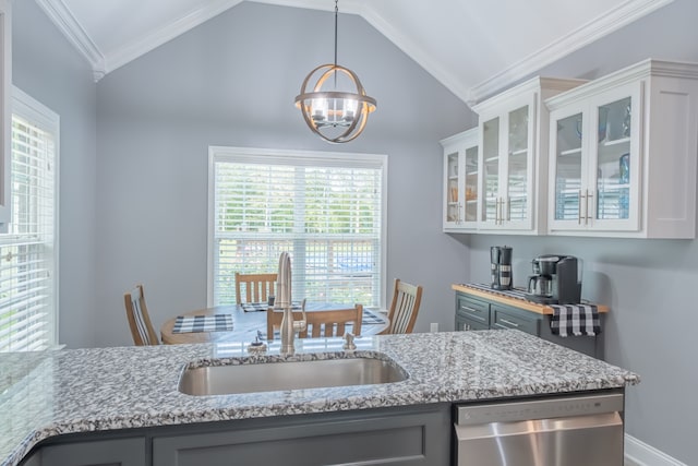 kitchen featuring a wealth of natural light, dishwasher, sink, vaulted ceiling, and hanging light fixtures