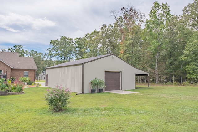 view of outdoor structure with a yard and a garage