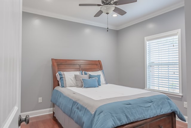 bedroom with ceiling fan, ornamental molding, and dark hardwood / wood-style flooring