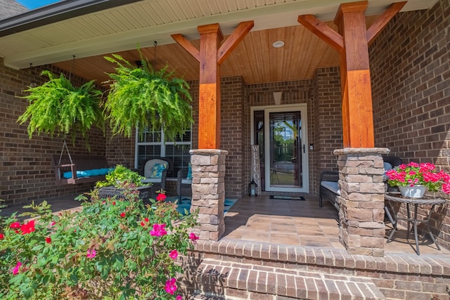 view of exterior entry with a porch