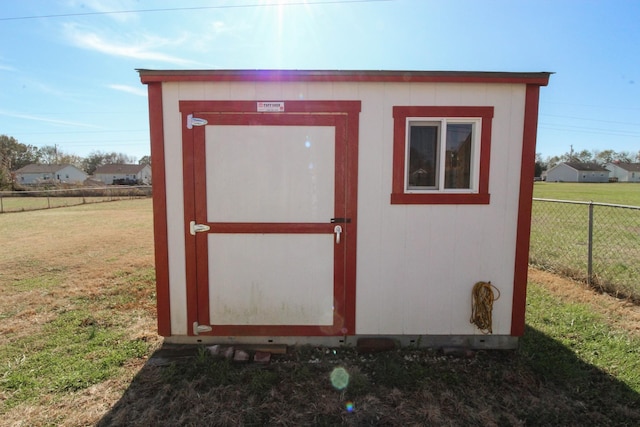 view of shed featuring fence