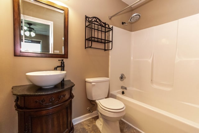 full bath featuring washtub / shower combination, vanity, toilet, and baseboards