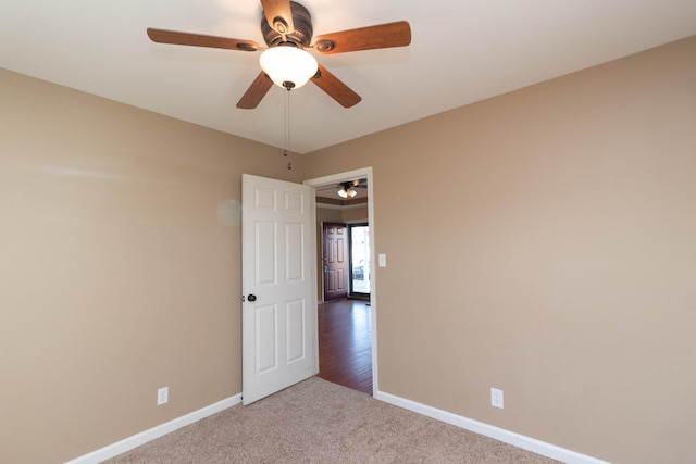 unfurnished room featuring carpet floors and baseboards