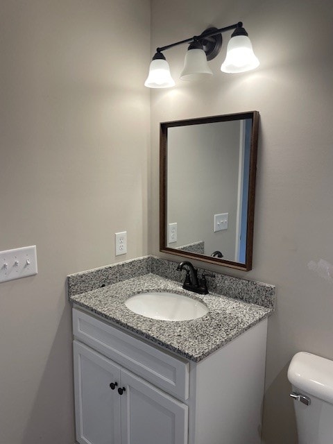 bathroom featuring toilet and vanity