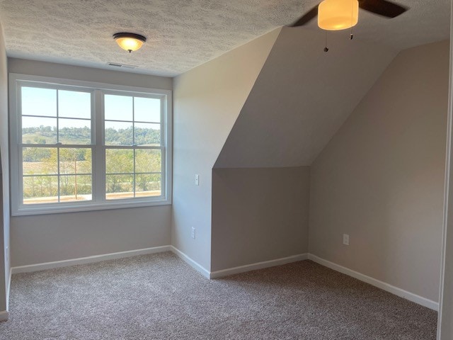 bonus room with carpet, vaulted ceiling, and a healthy amount of sunlight