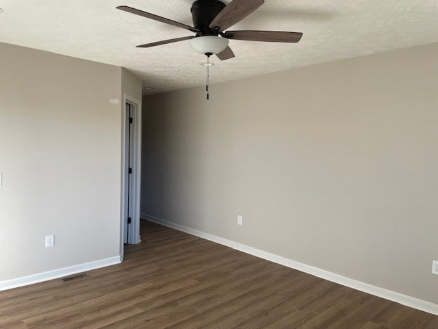 unfurnished room featuring ceiling fan, a textured ceiling, and dark hardwood / wood-style floors