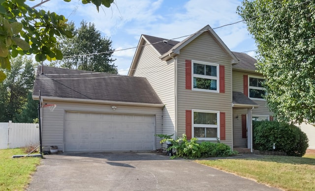 view of front of property with fence, driveway, a shingled roof, a front lawn, and a garage