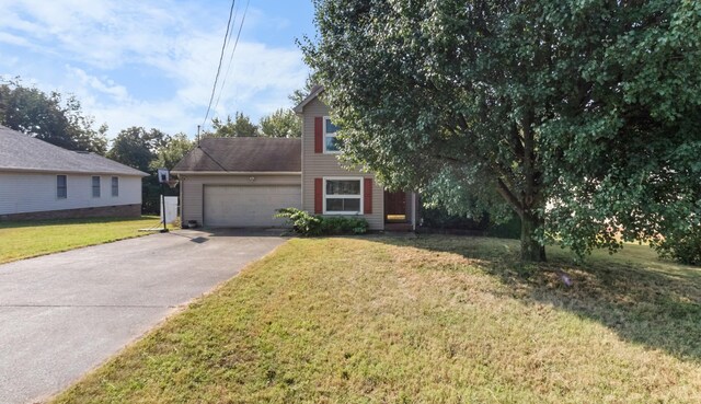 view of front of house with a front yard and a garage